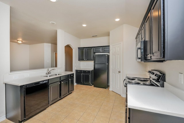 3153 Evangeline Rd, Fort Worth, TX 76140 - kitchen with black appliances, arched walkways, light countertops, recessed lighting, and light tile patterned floors