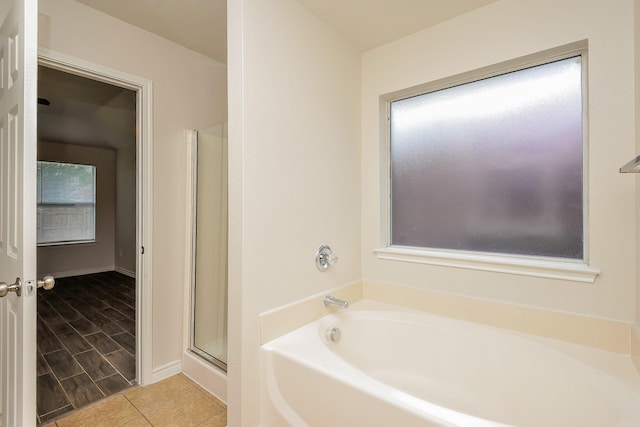3153 Evangeline Rd, Fort Worth, TX 76140 - bathroom with a bath, a shower with shower door, and tile patterned floors