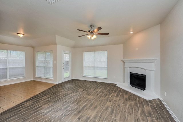 3153 Evangeline Rd, Fort Worth, TX 76140 - unfurnished living room with wood finished floors, ceiling fan, and a fireplace with raised hearth