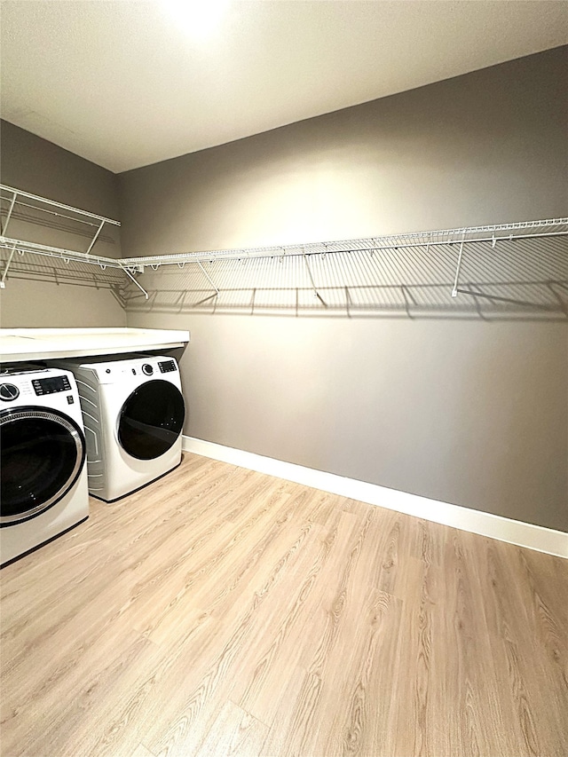 3517 Windhaven Pkwy Unit 1209, Lewisville, TX 75056 - laundry area featuring washing machine and dryer and wood finished floors