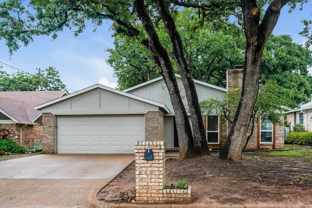 5903 Cameron Dr, Arlington, TX 76017 - view of front of home featuring concrete driveway, an attached garage, a chimney, and brick siding