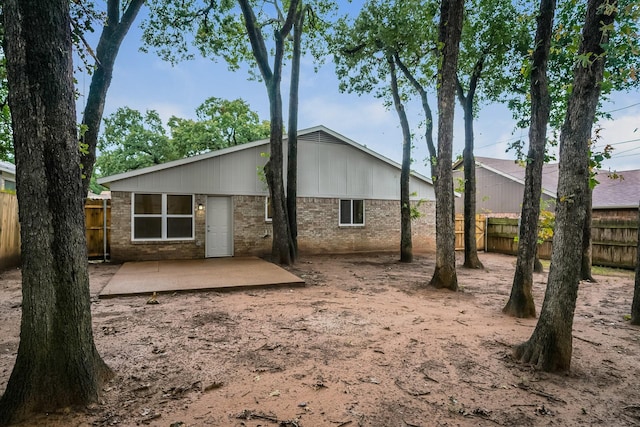 5903 Cameron Dr, Arlington, TX 76017 - back of property with brick siding and a patio area