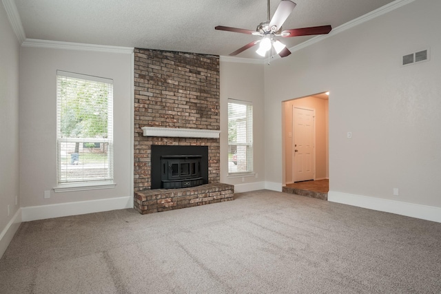 5903 Cameron Dr, Arlington, TX 76017 - unfurnished living room with plenty of natural light, carpet, crown molding, ceiling fan, and a wood stove