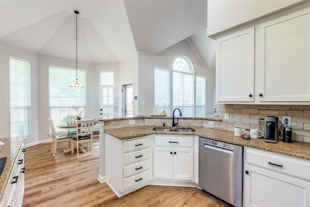 8600 Digby Dr, Plano, TX 75025 - kitchen with stainless steel dishwasher, lofted ceiling, a peninsula, light wood finished floors, and light stone countertops