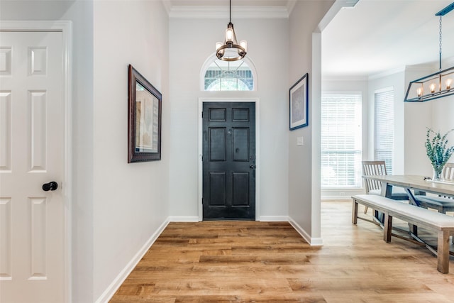 8600 Digby Dr, Plano, TX 75025 - foyer entrance with a chandelier, light wood-style floors, and crown molding