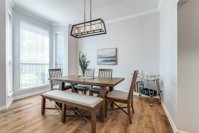 8600 Digby Dr, Plano, TX 75025 - dining room with light wood finished floors, healthy amount of natural light, ornamental molding, and a chandelier