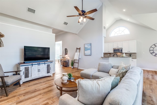 8600 Digby Dr, Plano, TX 75025 - living area featuring high vaulted ceiling, a ceiling fan, and light wood-style flooring