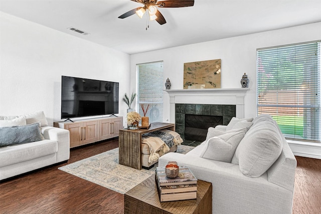2904 Champlin Ct, Richardson, TX 75082 - living room featuring a tile fireplace, ceiling fan, and dark wood-type flooring