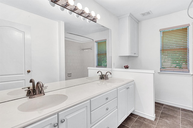 2904 Champlin Ct, Richardson, TX 75082 - full bath featuring double vanity, tile patterned flooring, and tiled shower
