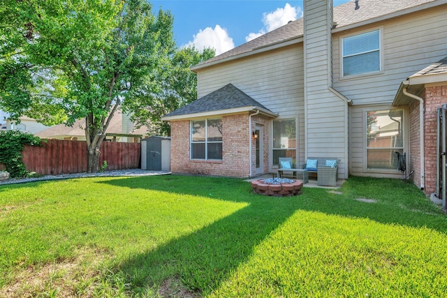 2904 Champlin Ct, Richardson, TX 75082 - back of house with a storage shed, brick siding, a shingled roof, a chimney, and an outdoor living space with a fire pit