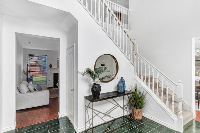 2904 Champlin Ct, Richardson, TX 75082 - stairs with tile patterned floors, a fireplace, and a high ceiling