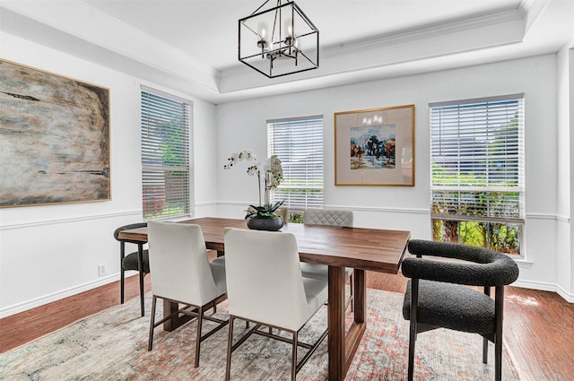 2904 Champlin Ct, Richardson, TX 75082 - dining space with a raised ceiling, crown molding, wood finished floors, and a chandelier