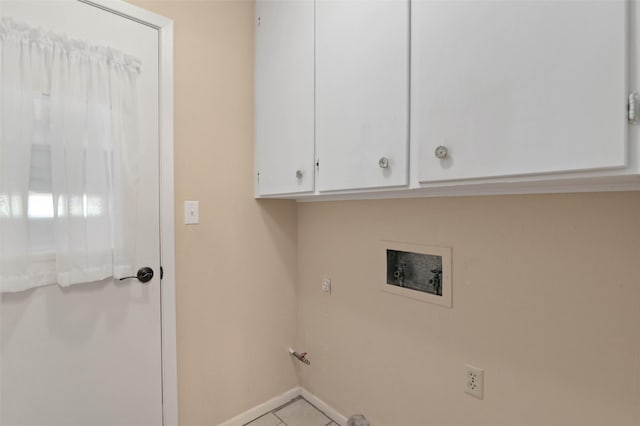 1509 Jefferson St, Bowie, TX 76230 - laundry area featuring washer hookup, tile patterned floors, and cabinet space