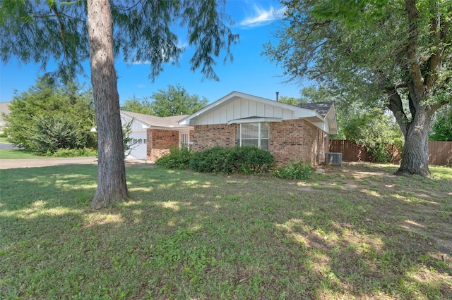 1509 Jefferson St, Bowie, TX 76230 - view of front of home featuring brick siding, a garage, and board and batten siding