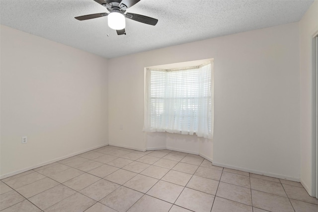 1509 Jefferson St, Bowie, TX 76230 - spare room with light tile patterned flooring, a textured ceiling, and a ceiling fan