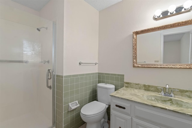 1509 Jefferson St, Bowie, TX 76230 - full bath with a shower stall, tile walls, vanity, and a wainscoted wall