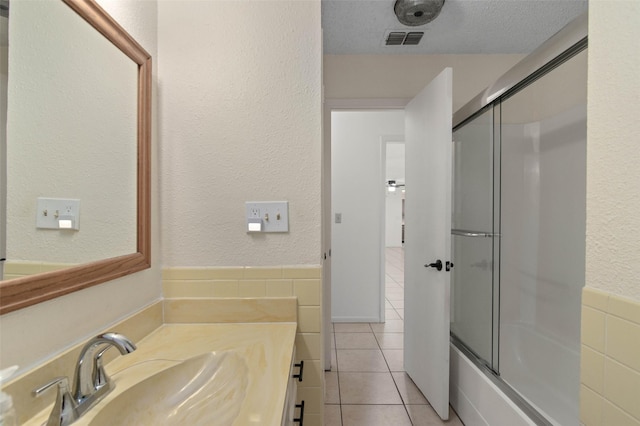 1509 Jefferson St, Bowie, TX 76230 - full bath with tile patterned floors, vanity, and bath / shower combo with glass door
