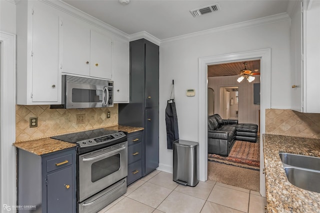 3933 Baltimore Ave, Shreveport, LA 71106 - kitchen with appliances with stainless steel finishes, decorative backsplash, crown molding, white cabinetry, and light tile patterned flooring