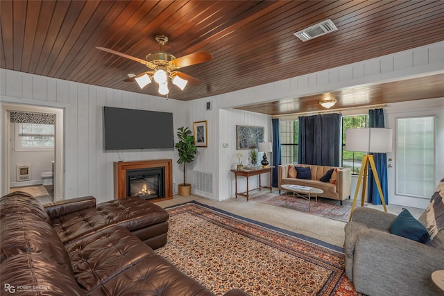 3933 Baltimore Ave, Shreveport, LA 71106 - living room with a glass covered fireplace, wooden ceiling, ceiling fan, and carpet