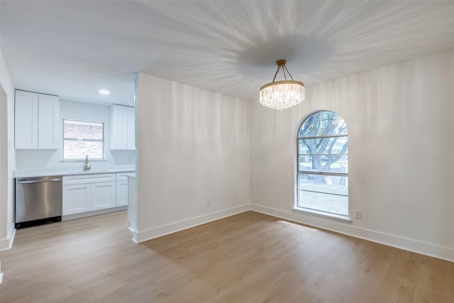 3525 S Elm Dr, Grand Prairie, TX 75052 - unfurnished dining area featuring light wood-style flooring and a chandelier
