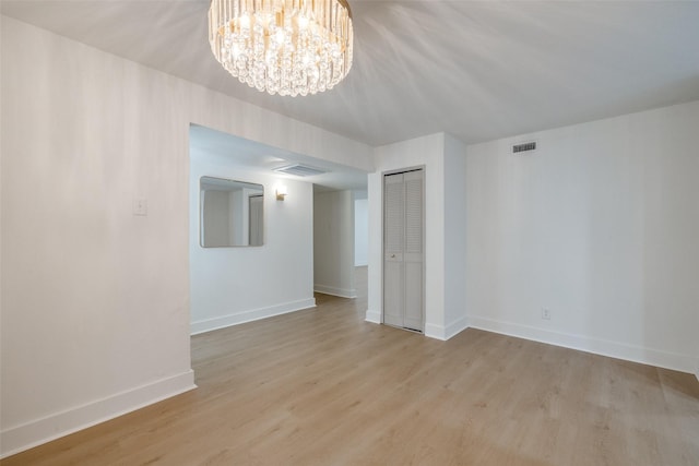 3525 S Elm Dr, Grand Prairie, TX 75052 - unfurnished room featuring a chandelier and wood finished floors