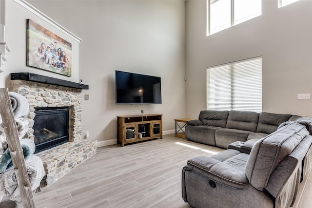 11825 Wulstone Rd, Fort Worth, TX 76052 - living room with light wood-style floors, a towering ceiling, and a fireplace