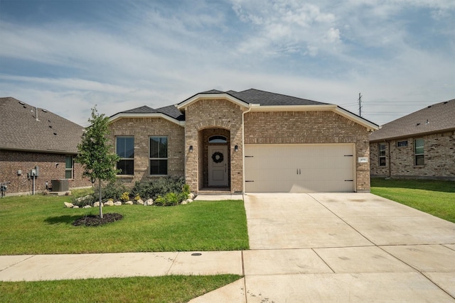 171 Tanager Dr, Rhome, TX 76078 - view of front of house with brick siding, a garage, concrete driveway, a front yard, and roof with shingles