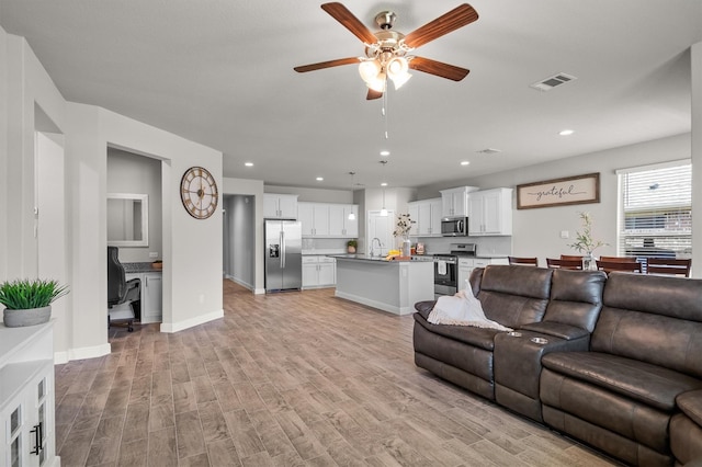 171 Tanager Dr, Rhome, TX 76078 - living room with light wood-style flooring, a ceiling fan, and recessed lighting