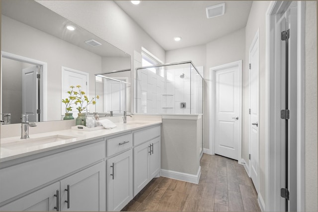 171 Tanager Dr, Rhome, TX 76078 - bathroom with double vanity, a stall shower, wood finished floors, and recessed lighting