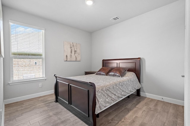 171 Tanager Dr, Rhome, TX 76078 - bedroom featuring light wood finished floors and multiple windows