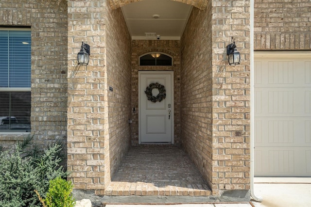 171 Tanager Dr, Rhome, TX 76078 - view of exterior entry featuring brick siding and a surveillance system