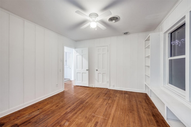 917 W Washington St, Sherman, TX 75092 - empty room featuring a decorative wall, wood finished floors, and ceiling fan