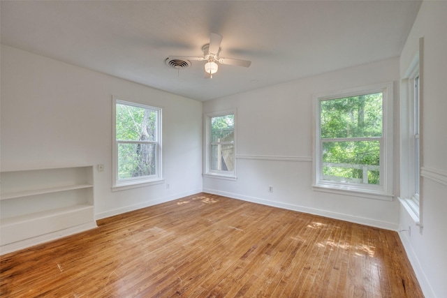 917 W Washington St, Sherman, TX 75092 - spare room featuring hardwood / wood-style floors, ceiling fan, and built in features