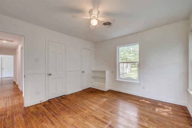 917 W Washington St, Sherman, TX 75092 - unfurnished bedroom with wood finished floors and a ceiling fan