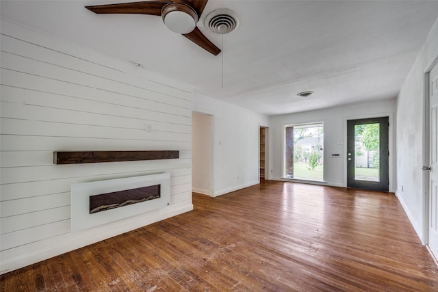 917 W Washington St, Sherman, TX 75092 - unfurnished living room featuring a fireplace, hardwood / wood-style flooring, and ceiling fan