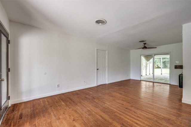 917 W Washington St, Sherman, TX 75092 - unfurnished living room featuring wood finished floors and ceiling fan