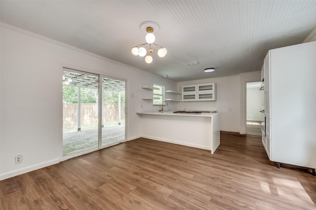 917 W Washington St, Sherman, TX 75092 - kitchen featuring open shelves, a peninsula, light countertops, ornamental molding, and white cabinetry