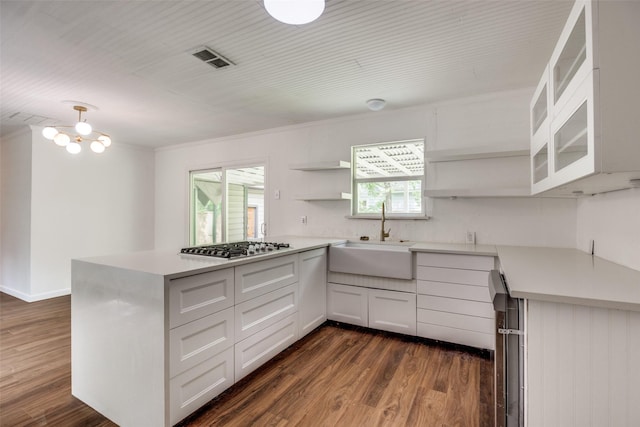 917 W Washington St, Sherman, TX 75092 - kitchen featuring open shelves, a peninsula, light countertops, and dark wood-type flooring