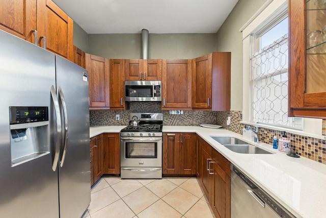 5502 Victor, Dallas, TX 75214 - kitchen featuring appliances with stainless steel finishes, light countertops, light tile patterned floors, and decorative backsplash