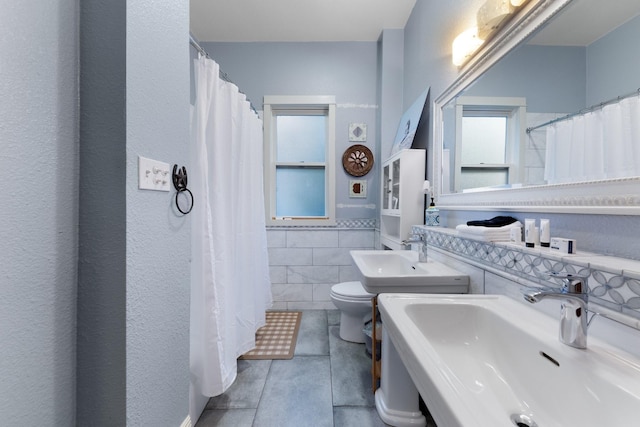 5502 Victor, Dallas, TX 75214 - full bathroom with tile walls, a wainscoted wall, and a shower with shower curtain