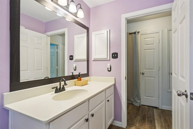 312 Robertson St, Denton, TX 76205 - bathroom featuring vanity, wood finished floors, and curtained shower