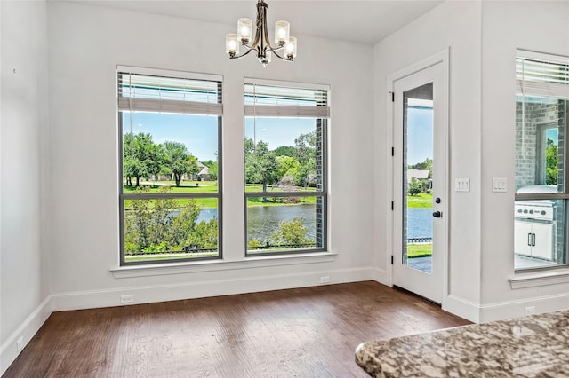 2604 Silverado Trl, Sherman, TX 75092 - unfurnished dining area featuring a chandelier, wood finished floors, and a water view