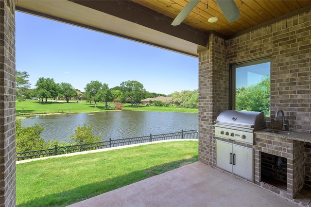 2604 Silverado Trl, Sherman, TX 75092 - fenced backyard featuring an outdoor kitchen, a water view, a patio, and a ceiling fan