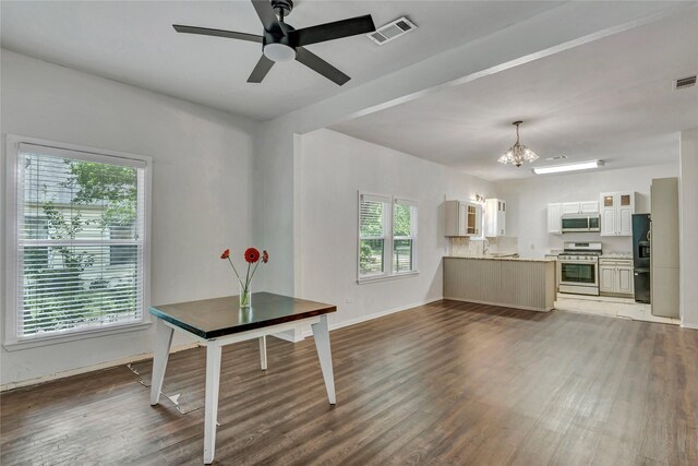 416 W Willingham St, Cleburne, TX 76033 - unfurnished dining area featuring a chandelier, healthy amount of natural light, and wood finished floors