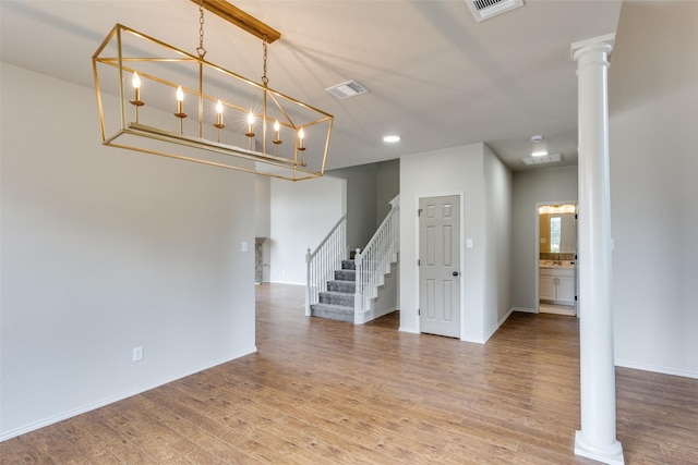 1432 Stillforest Dr, Allen, TX 75002 - unfurnished room featuring stairway, wood finished floors, decorative columns, and recessed lighting