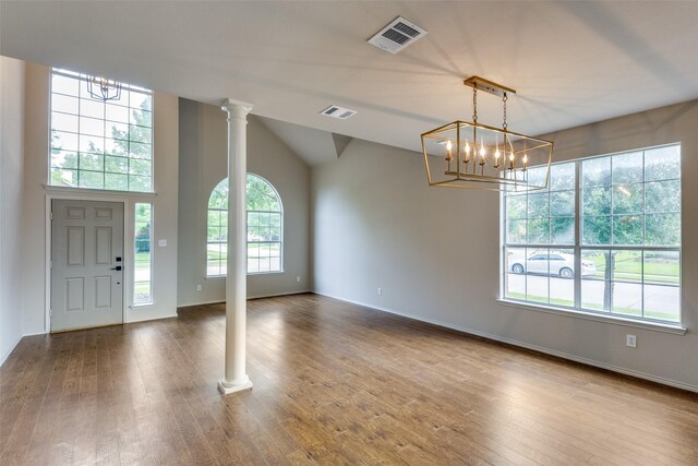1432 Stillforest Dr, Allen, TX 75002 - entryway featuring a chandelier, decorative columns, wood finished floors, and vaulted ceiling