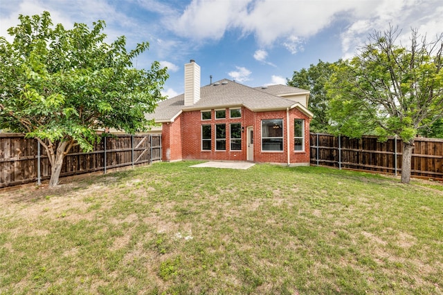 1432 Stillforest Dr, Allen, TX 75002 - back of property featuring brick siding, a patio, a chimney, a fenced backyard, and roof with shingles