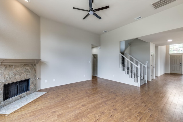 1432 Stillforest Dr, Allen, TX 75002 - unfurnished living room with stairs, ceiling fan, wood finished floors, and a fireplace