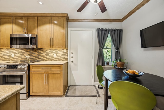 11330 Park Central Pl Unit C, Dallas, TX 75230 - kitchen with stainless steel appliances, crown molding, tasteful backsplash, brown cabinetry, and a ceiling fan
