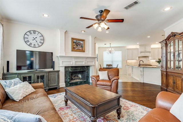 6328 Birchmont Dr, Plano, TX 75093 - living area with ceiling fan, crown molding, dark wood finished floors, recessed lighting, and a fireplace